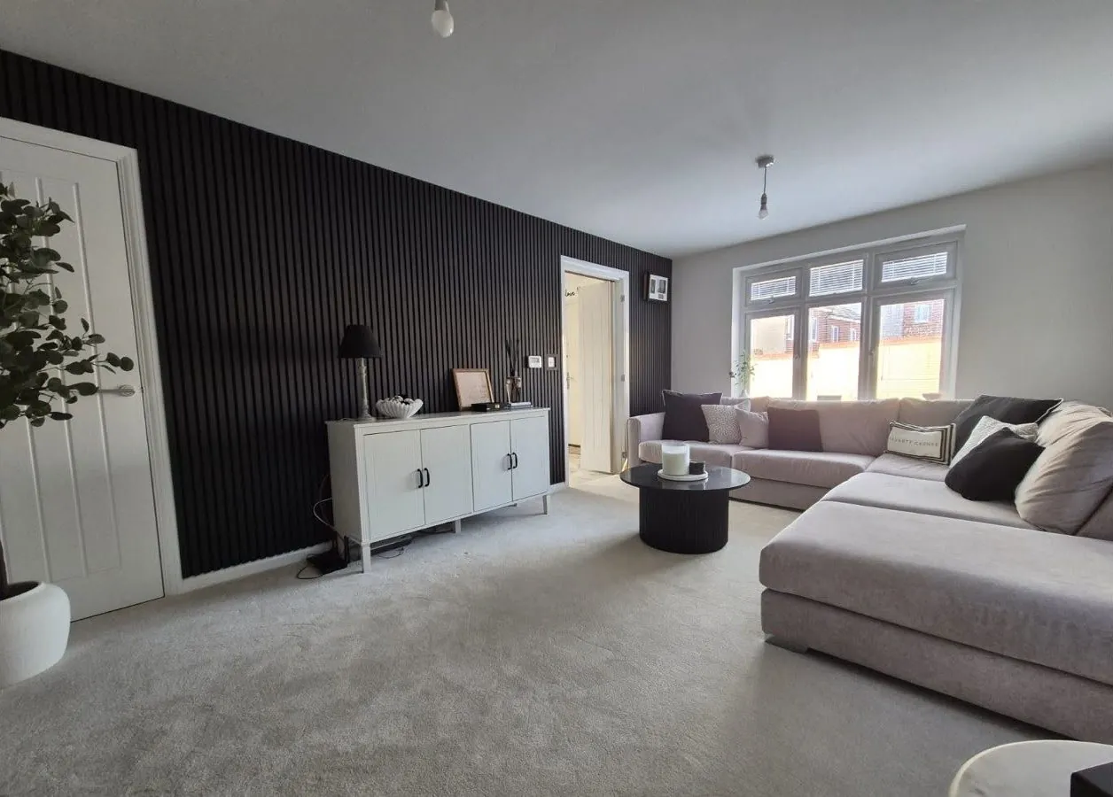 Black slatted wall panelling in a living room – carpentry by JCK Carpentry & Building, Exeter